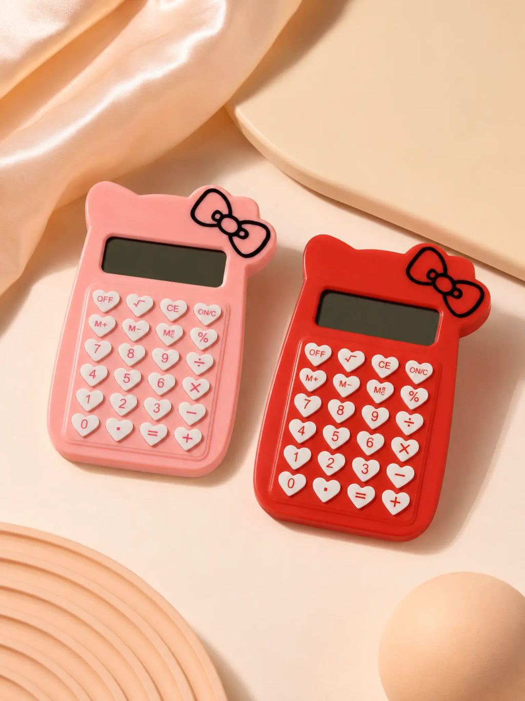 Pink and red bow calculators with heart-shaped keys