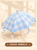 Doggie Umbrella open blue checked canopy with dog on crown and dog charms hanging from rib tips