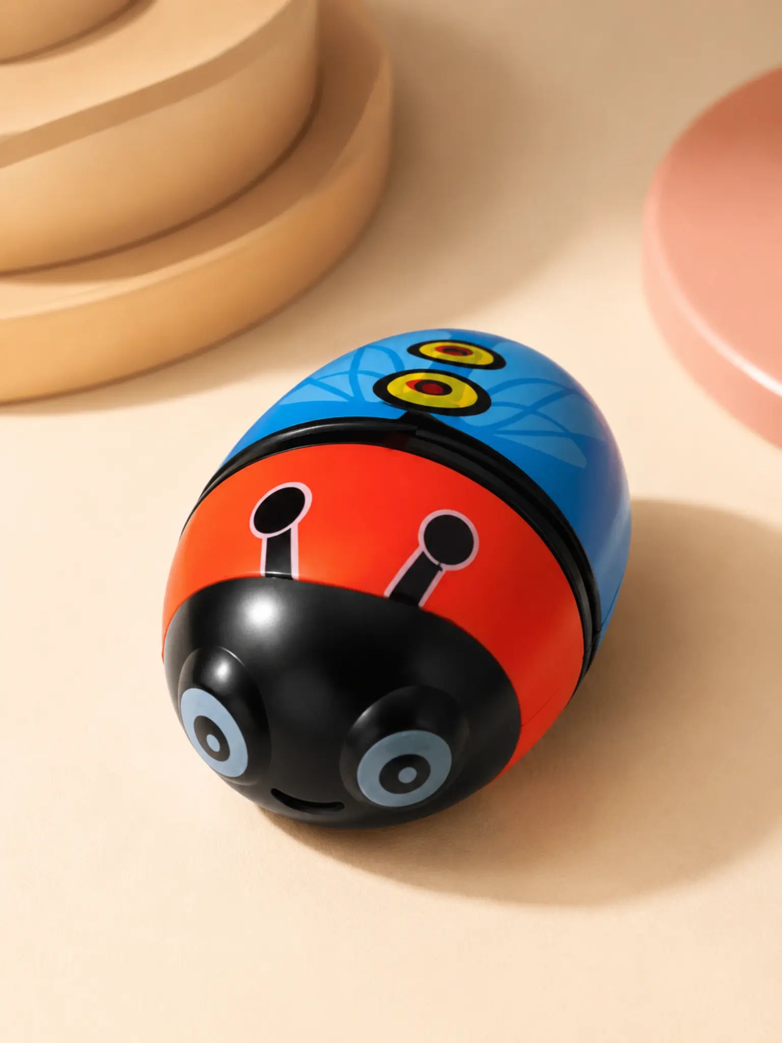 Ladybug eraser and sharpener in warm studio lighting