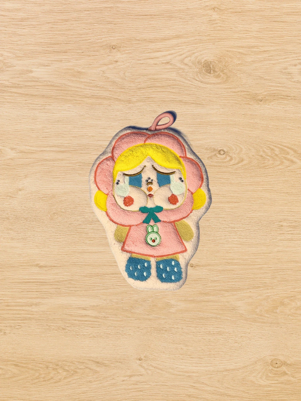 Hand Towel Design E photographed from directly above on a natural wooden tabletop