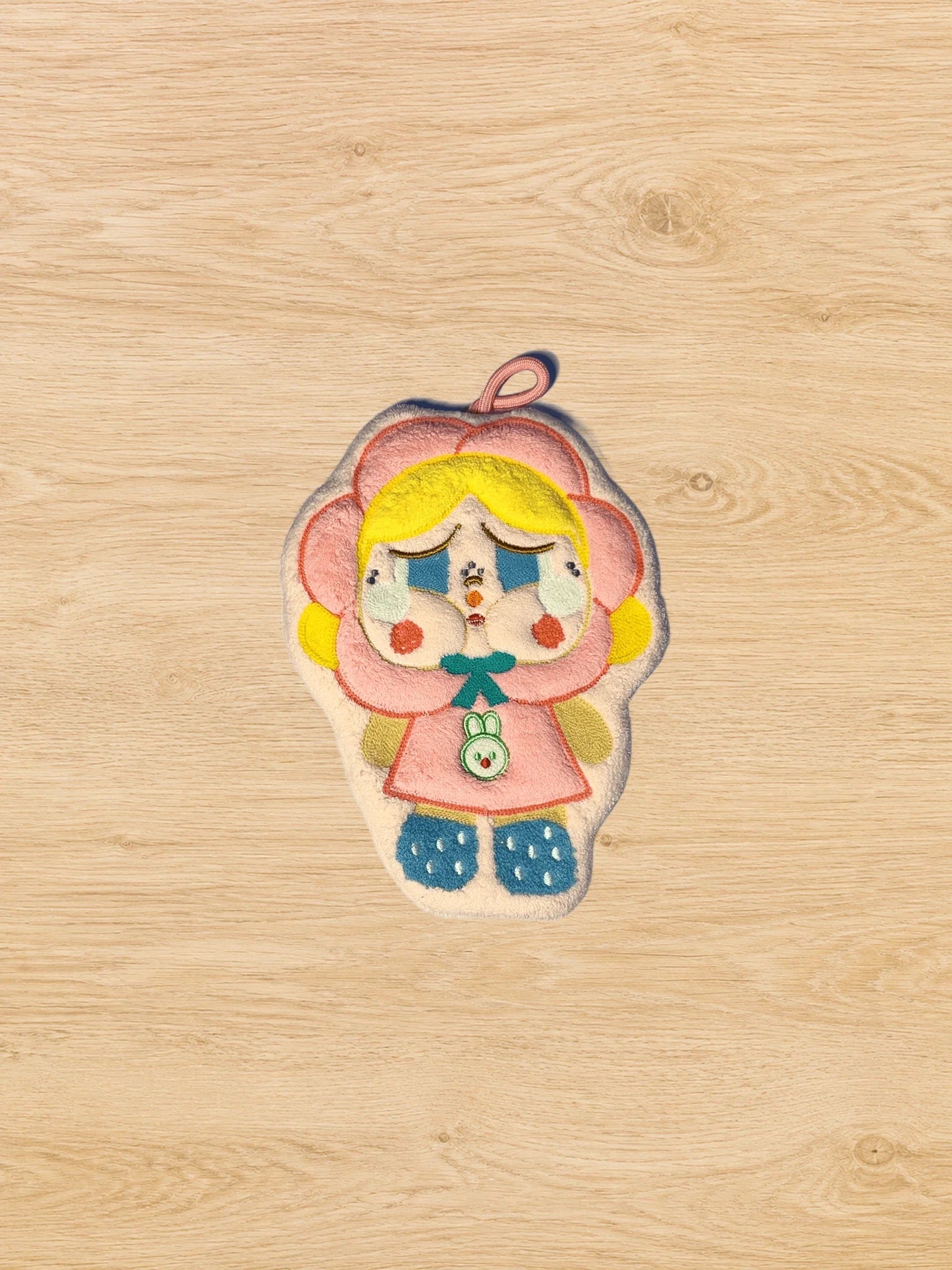 Hand Towel Design E photographed from directly above on a natural wooden tabletop