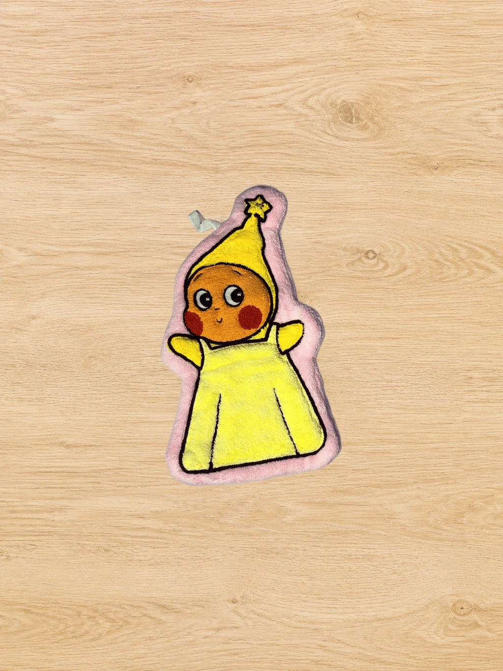 Hand Towel Design H photographed from directly above on a natural wooden tabletop