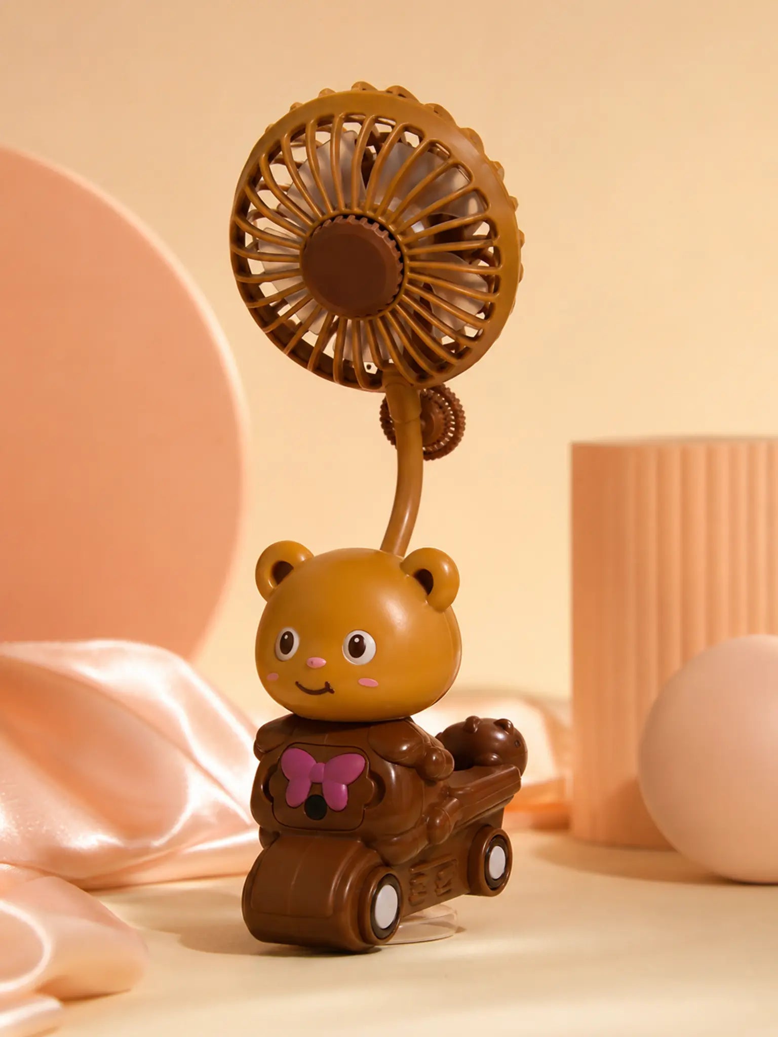 Brown bear mini fan with lights in warm peach studio lighting