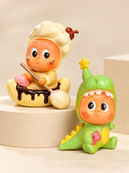 Star People cream chef and green dinosaur collectible blind box figures on an ivory display platform