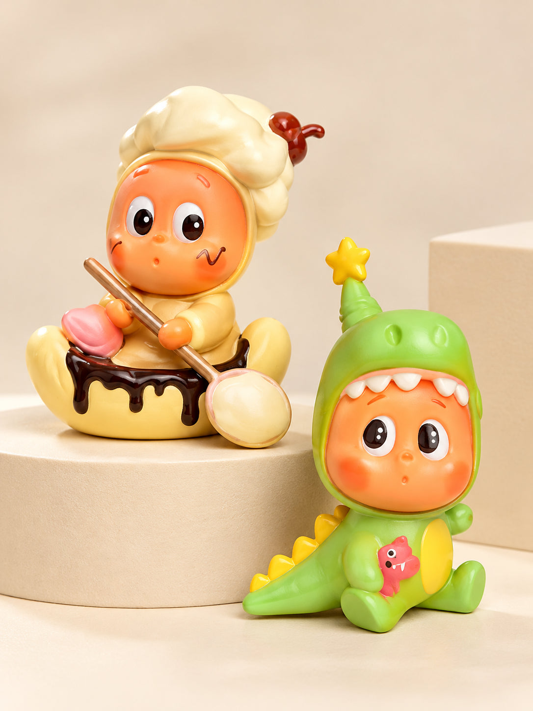 Star People cream chef and green dinosaur collectible blind box figures on an ivory display platform